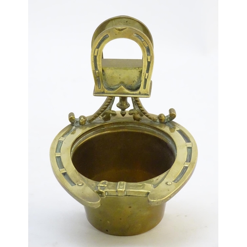 404 - A 19thC brass smoker's companion, comprising ashtray and vesta holder with cast horse shoe and stirr... 