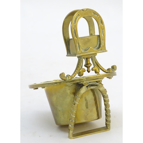 404 - A 19thC brass smoker's companion, comprising ashtray and vesta holder with cast horse shoe and stirr... 