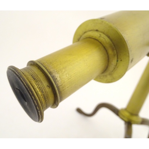 1042 - A 19thC brass two-draw telescope and removable folding tripod stand, the extended barrel measuring 5... 