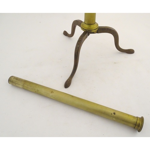 1042 - A 19thC brass two-draw telescope and removable folding tripod stand, the extended barrel measuring 5... 