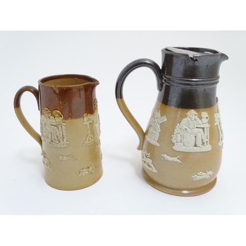 56 - A Royal Doulton and Doulton Lambeth two tone stoneware jugs decorated with hunting scenes in relief.... 