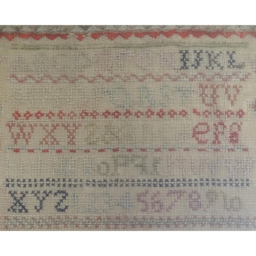 1027 - A Victorian needlework sampler decorated with the alphabet letter, numbers, numbers and the text Ann... 