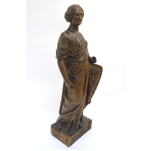 1030 - An 18th-19thC carved walnut statuette, depicting a classical female with shield, standing 34