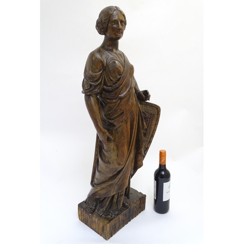 1030 - An 18th-19thC carved walnut statuette, depicting a classical female with shield, standing 34