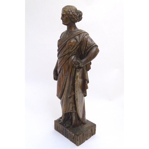 1030 - An 18th-19thC carved walnut statuette, depicting a classical female with shield, standing 34