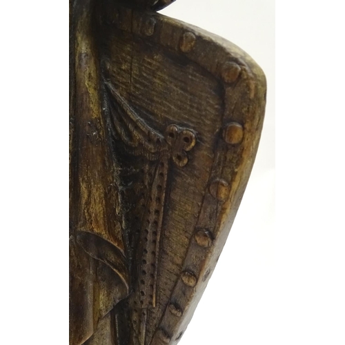 1030 - An 18th-19thC carved walnut statuette, depicting a classical female with shield, standing 34