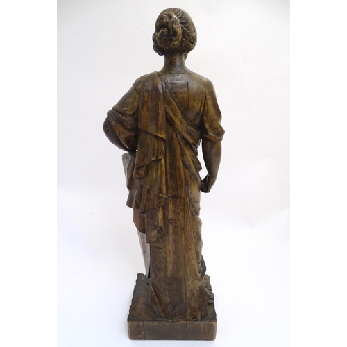 1030 - An 18th-19thC carved walnut statuette, depicting a classical female with shield, standing 34