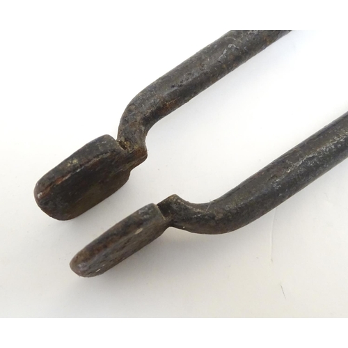 1031 - A Victorian pair of cast iron fire tongs, 27