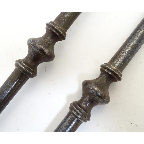 1031 - A Victorian pair of cast iron fire tongs, 27