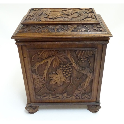 1032 - A 19thC Chinese hardwood table cabinet, with carved foliate and floral decoration, the lid with depi... 