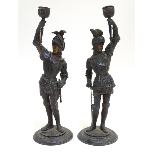 1035 - A pair of early 20thC candlesticks formed as French armoured knights, each measuring 15