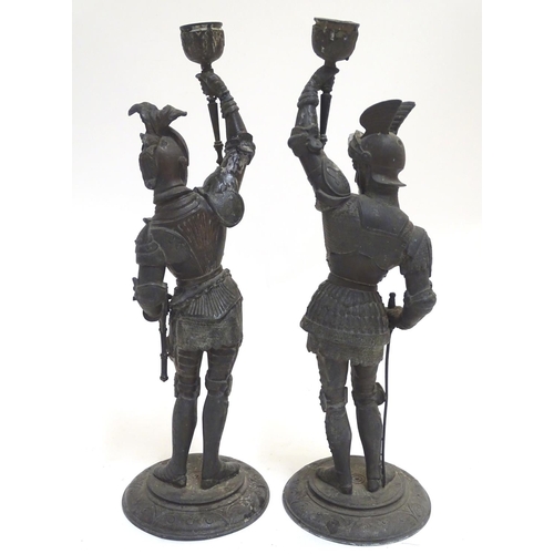 1035 - A pair of early 20thC candlesticks formed as French armoured knights, each measuring 15