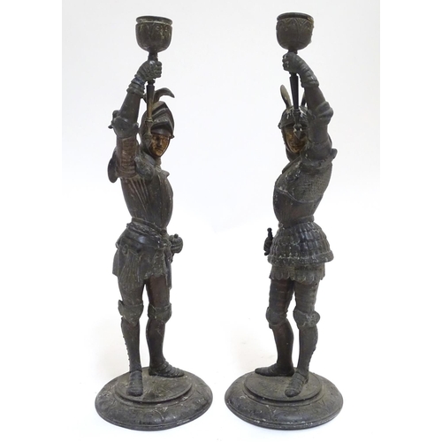 1035 - A pair of early 20thC candlesticks formed as French armoured knights, each measuring 15