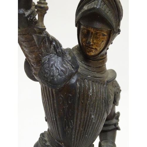 1035 - A pair of early 20thC candlesticks formed as French armoured knights, each measuring 15