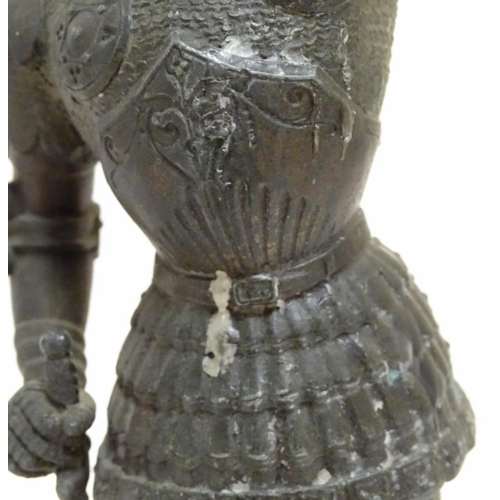 1035 - A pair of early 20thC candlesticks formed as French armoured knights, each measuring 15