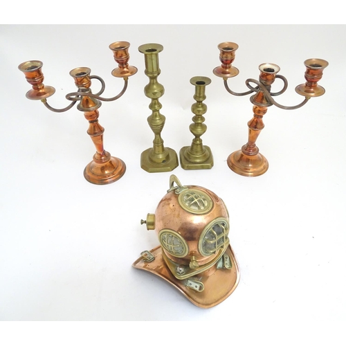 1038 - A selection of copper and brass items, comprising a pair of copper candelabra, two brass candlestick... 