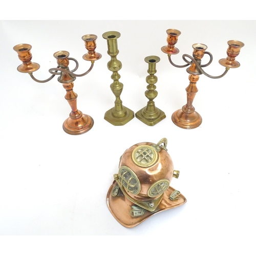 1038 - A selection of copper and brass items, comprising a pair of copper candelabra, two brass candlestick... 