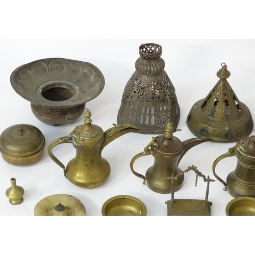 1039 - An assortment of Eastern metalware, including teapots, dishes, pendant lamp shades, various shisha p... 