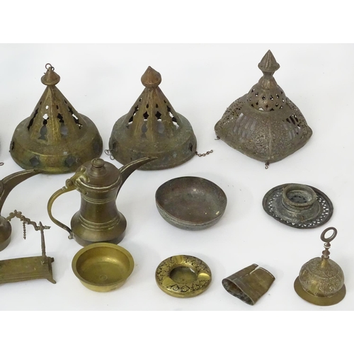 1039 - An assortment of Eastern metalware, including teapots, dishes, pendant lamp shades, various shisha p... 