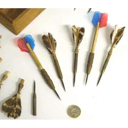 210 - A box of vintage darts some with feather flights contained within a wooden box. Approx. 7 pieces.