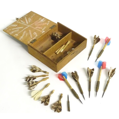 210 - A box of vintage darts some with feather flights contained within a wooden box. Approx. 7 pieces.