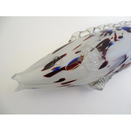 192 - A Murano glass model of a fish, decorated in white with red and blue flecks. 18 1/4