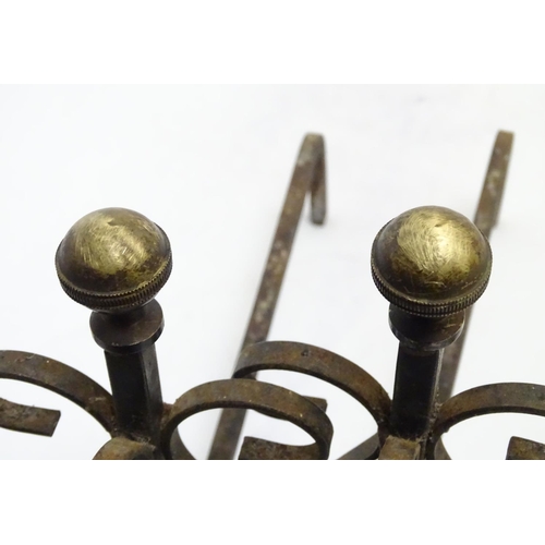 214 - Garden & Architectural, Salvage: a pair of early 20thC wrought iron and brass fire dogs, approximate... 