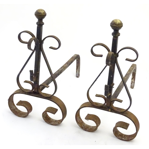 214 - Garden & Architectural, Salvage: a pair of early 20thC wrought iron and brass fire dogs, approximate... 