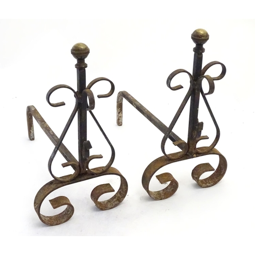 214 - Garden & Architectural, Salvage: a pair of early 20thC wrought iron and brass fire dogs, approximate... 