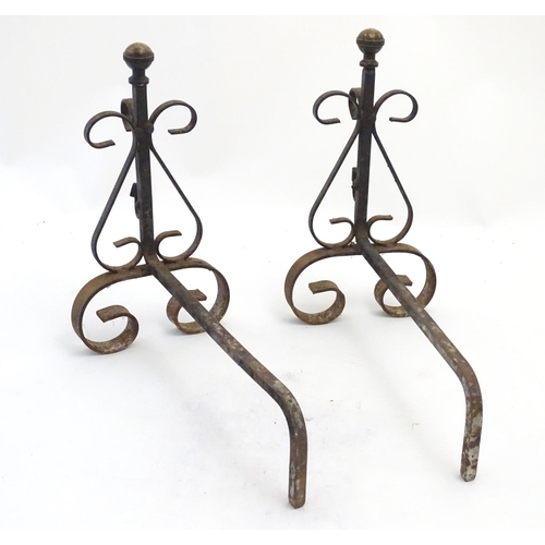 214 - Garden & Architectural, Salvage: a pair of early 20thC wrought iron and brass fire dogs, approximate... 