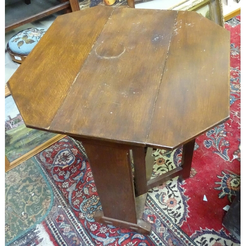 20 - A Cotswold school style oak drop flap table with a chamfered frame and exposed construction. 30'' lo... 