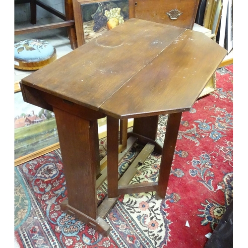 20 - A Cotswold school style oak drop flap table with a chamfered frame and exposed construction. 30'' lo... 