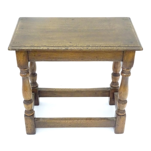 209 - A small mid 20thC peg jointed oak stool. Approx. 18