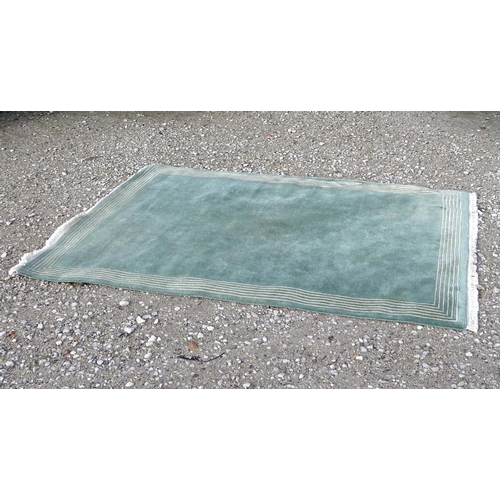219 - A large hall rug with a grey and blue ground with a white border. Approx. 68