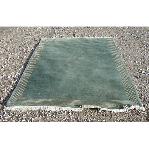 219 - A large hall rug with a grey and blue ground with a white border. Approx. 68