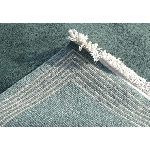 219 - A large hall rug with a grey and blue ground with a white border. Approx. 68