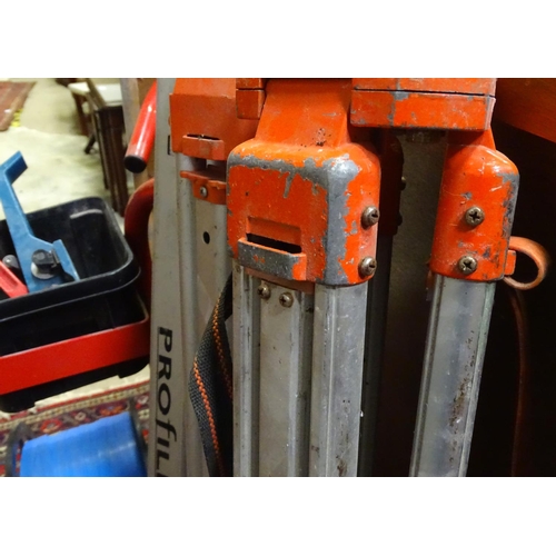 221 - Surveyor's equipment, to include tripods, a trolley, etc.
