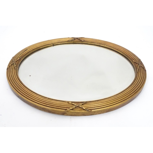 230 - An oval gilt framed mirror. Approx. 17
