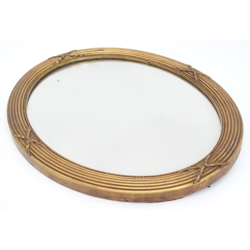 230 - An oval gilt framed mirror. Approx. 17