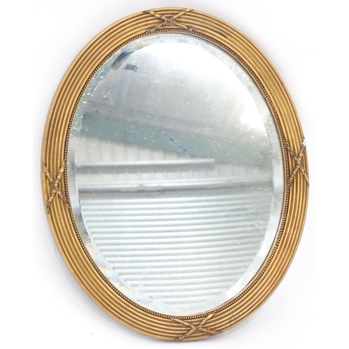 230 - An oval gilt framed mirror. Approx. 17