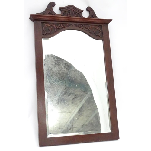 240 - A mirror with a carved mahogany surround. Approx. 34 1/2