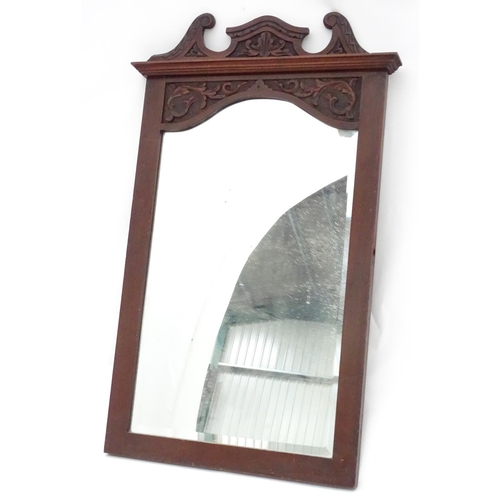 240 - A mirror with a carved mahogany surround. Approx. 34 1/2