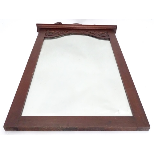 240 - A mirror with a carved mahogany surround. Approx. 34 1/2