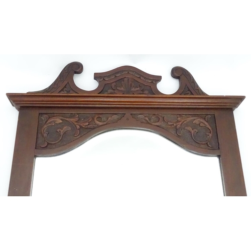 240 - A mirror with a carved mahogany surround. Approx. 34 1/2