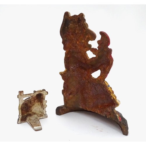 31 - A cast iron Punch and Judy door stop and a cow door stop. Largest approx. 11 2/2