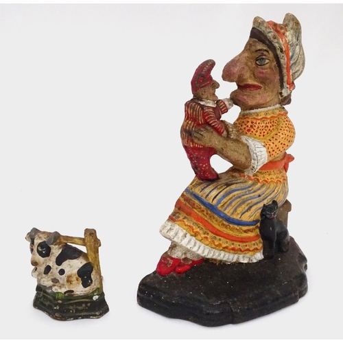 31 - A cast iron Punch and Judy door stop and a cow door stop. Largest approx. 11 2/2