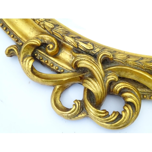 43 - A gilt mirror with cherub detail. Approx. 35 1/2