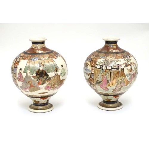 13 - A pair of Japanese Satsuma vases of globular form in the Kutani style with flared rims and feet. The... 