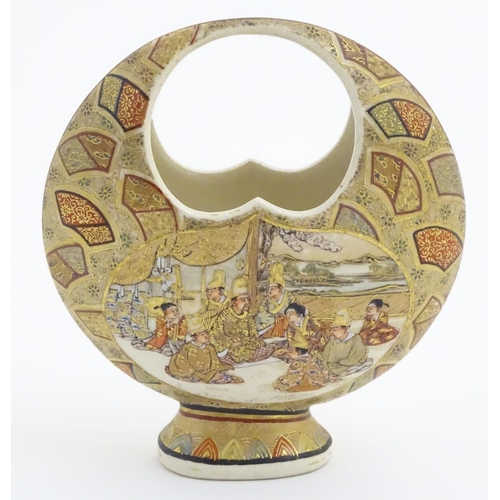 35 - A Japanese satsuma moon basket vase with hand painted decoration depicting figures seated around imp... 