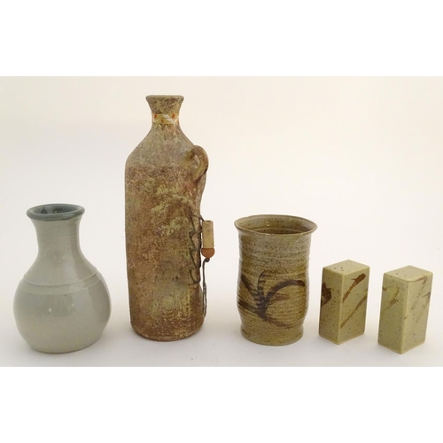 62 - A quantity of assorted studio pottery wares, to include vases, a salt and pepper of rectangular form... 